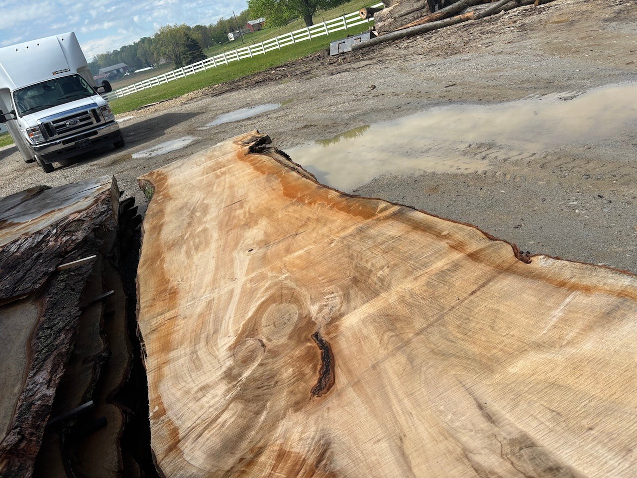 Before photo of raw, unfinished maple wood slab being prepared for a custom live-edge bar top project in Northeast Ohio.