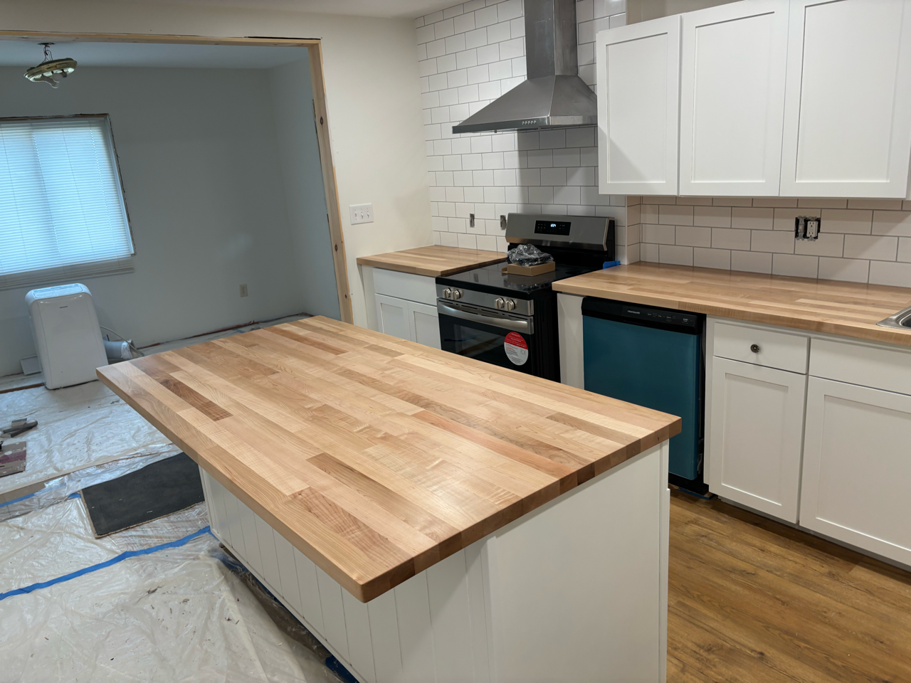 Kitchen remodel featuring custom white oak countertops and kitchen island with subway tile installation in Northeast OH